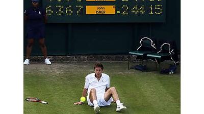 Nicolas Mahut slumps to the ground during his 10-hour epic with John Inser. Bad light suspended play, but the two will conclude tomorrow.