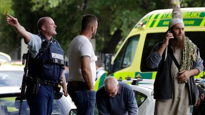 Police attempt to clear people from outside a mosque in central Christchurch, New Zealand. AP.