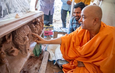 Swami Brahmavihari, head of international relations for Baps Swaminarayan Sanstha, the organisation building the temple in Abu Dhabi, checks the engravings in India. Photo: Baps Hindu Mandir