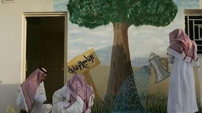 Yousef al Ramah and Abdullah Sharif paint on a tree of life with an art therapist at the Care Centre in Saudi Arabia.