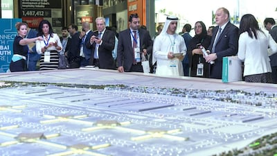 Above, the Dubai South stand at Cityscape Global in Dubai. Antonie Robertson / The National