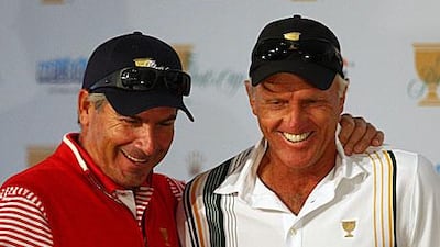 Fred Couples, the US captain, left, and Greg Norman, the International captain, discuss the first day's fourball pairings after the draw saw Tiger Woods playing against Adam Scott tomorrow.