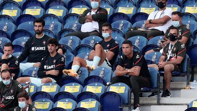 Portugal's Cristiano Ronaldo, centre right, sits next to the Portugal substitutes. AP Photo