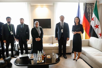 Razan Saffour with Syria's Foreign Minister Asaad Al Shibani as he meets German Foreign Minister Annalena Baerbock at the Munich Security Conference. AFP
