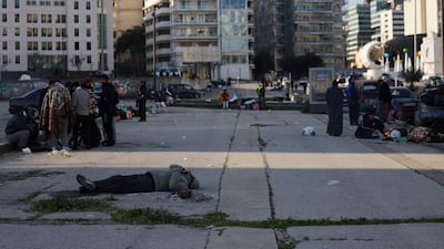 A man lies on the ground, as displaced people gather at Martyrs' Square in Beirut. Reuters