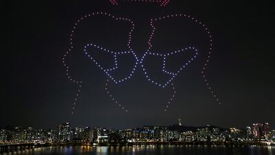 Drones fly over the Han river showing messages to support the country, as measures to avoid the spread of the coronavirus disease (COVID-19) continue, in Seoul, South Korea, July 4, 2020. Picture taken July 4, 2020. Yonhap via REUTERS ATTENTION EDITORS - THIS IMAGE HAS BEEN SUPPLIED BY A THIRD PARTY. SOUTH KOREA OUT. NO RESALES. NO ARCHIVE. TPX IMAGES OF THE DAY