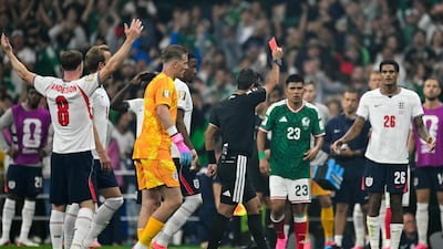 Australian referee Alireza Faghani shows a red card to England defender Jarell Quansah against Mexico. AFP