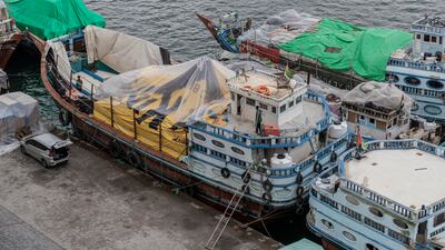 Cargo dhows with their loads covered in plastic sheets and old billboards to protect the goods from the rain. Antonie Robertson / The National