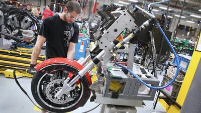 A worker builds the front end of a 2015 Victory Cross Country motorcycle on the Polaris assembly line in Spirit Lake, Iowa. Scott Olson / Getty Images / AFP