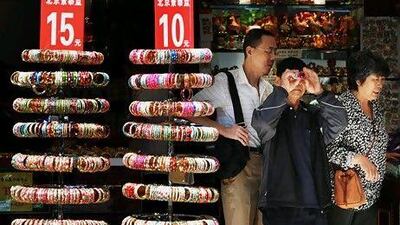 Customers in the Wangfujing shopping street in Beijing. Figures from the country sugest retail sales growth is slowing. Mark Ralston / AFP
