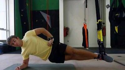 1. Adjust the TRX to mid-calf length. Lay on your side with both feet in the foot cradles. The foot on top should be slightly in front, keeping the locking loop even. Rest on your elbow, placing your other hand on your hip.