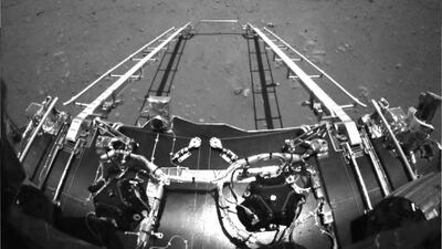 An image taken by an obstacle avoidance camera installed in front of China's Zhurong rover on the surface of Mars, showing a ramp on the lander that has been extended to the surface of the planet. EPA