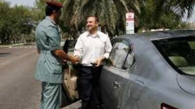Major Ahmed Al Niyadi rewards Hatem Abdullah for his safe driving practices.