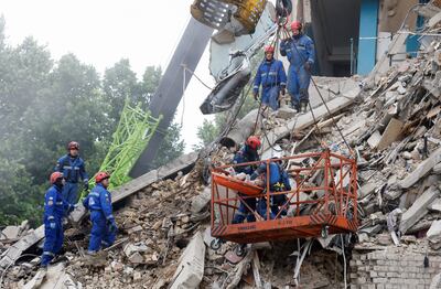 Rescuers carry a body out of an apartment building in Kyiv after the major Russian attack. Reuters