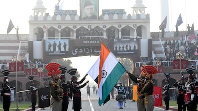 Indian Border Security Force personnel (dressed in brown) and Pakistani Rangers (dressed in black) take part in the Beating Retreat ceremony at the India-Pakistan Wagah border post on January 26, 2022. Narinder Nanu / AFP