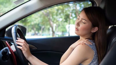 Hand position on the steering wheel can help prevent back pain. Getty