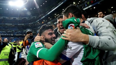 Leganes' Diego Rico, left, celebrates with fans after a 2-2 draw in the quarter-final second leg of their Copa del Rey match against Real Madrid at the Bernabeu. Juanjo Martin / EPA