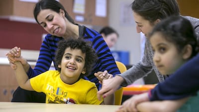 Students at the New England Center for Children participate in group singing at the center for autistic children in Mohamed bin Zayed City. (Silvia Razgova / The National)