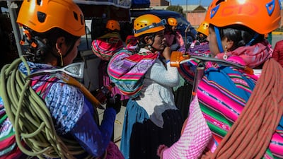 Aymara indigenous women climbers waiting for the bus to take them to the base of Huayna Potosi.