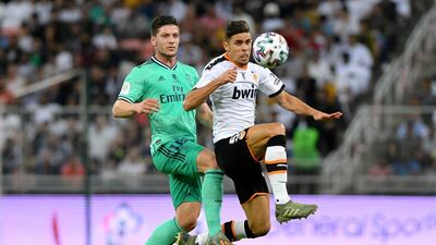 Valencia's Gabriel Paulista in action with Real Madrid's Luka Jovic during the Spanish Super Cup in Jeddah. Reuters