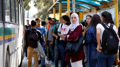 Youths wait for the bus outside Manar university in Tunis, Tunisia. Reuters