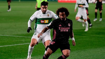 Real Madrid's Marcelo challenges Elche's Antonio Barragan. AFP