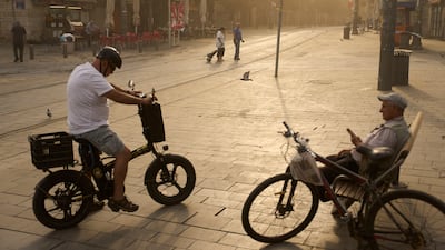 People walk through Jerusalem's Mahane Yehuda Market during a heat wave. AP