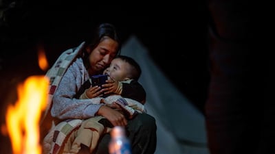 Mexican migrants keep warm by a fire while waiting to be apprehended by US Customs and Border Patrol officers in Ruby, Arizona. AFP