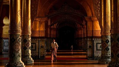 A visitor admires the grandeur of Mahar Myat Muni pagoda in Mandalay, Myanmar. AFP