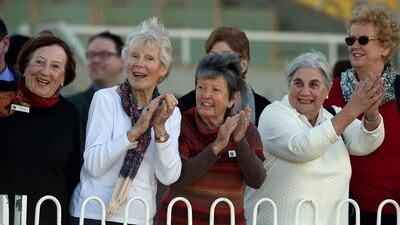 Spectators cheering at camel racing carnival.