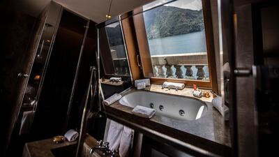 A bathtub overlooking the lake, reflected on a bathroom mirror of the historical Grand Hotel Tremezzo, in Tremezzo, on Como Lake, Italy. The hotel was built in 1901. AP Photo / Luca Bruno