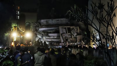 Rescue teams search for survivors on the debris of a residential building that collapsed in Lucknow on January 24, 2023. (Photo by AFP)