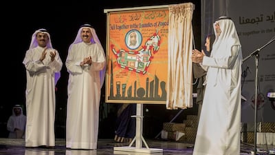 Sheikh Nahyan bin Mubarak, Minister of Culture and Knowledge Development, Sheikha Lubna Al Qasimi, Minister of State for Tolerance, Saqr Ghobash, Minister of Human Resources, and Dr Abdullah Al Nuaimi, Minister of Infrastructure Development, unveil a plaque to celebrate International Workers Day at a gathering for expatriate workers on Yas Island. Vidhyaa for The National