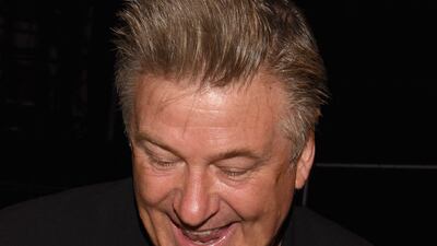 Alec Baldwin holds son Rafael Baldwin backstage at the Carmen Marc Valvo spring/summer 2016 show during New York Fashion Week, in September 2015. Getty