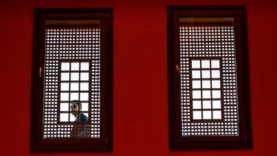 A security guard looks through a window at the American University Cairo, in Egypt. AFP