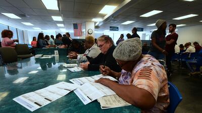 Voters fill out their ballots for early voting at the Los Angeles County Registrar's Office in Norwalk, California. AFP