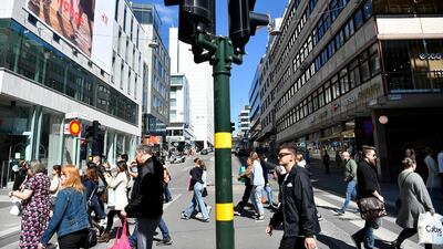 People walk in Drottninggatan during the coronavirus pandemic in central Stockholm, Sweden EPA