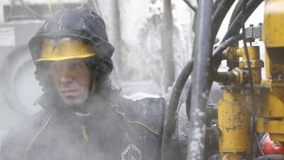 An employee works at a drilling site at Rosneft's Suzunskoye oilfield in Siberia. The company's oil and gas condensate output for the July to September period was down 3.2 per cent from the previous quarter at 3.91m bpd. REUTERS