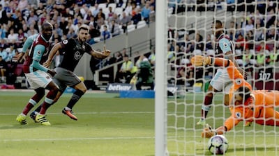 Southampton’s Charlie Austin, second left, scores his side’s first goal against West Ham. Matt Dunham / AP Photo