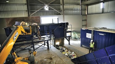 The unsorted rubbish is dumped onto a conveyor belt