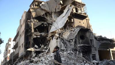 A Syrian man walks past a damaged building in the northwestern border town of Al Bab after Turkish-backed rebels announced the recapture of the town from ISIL (AFP / Nazeer al-Khatib)