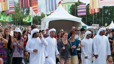 Members of the Abu Dhabi Folk Dance Group perform with the crowd at Womad UK last week. The group gave its first international performance at the festival.