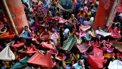Hindu devotees collect rice distributed for the Annakut, or Govardhan Puja, festival at the Madan Mohan temple in Kolkata, India. AFP