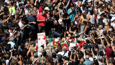 A woman places a bouquet of flowers at Las Ramblas the day after a van crashed into pedestrians in Barcelona, Spain August 18, 2017. REUTERS/Sergio Perez