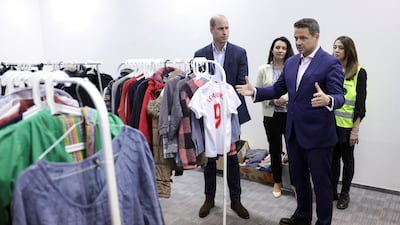 Prince William and Mayor of Warsaw Rafal Trzaskowski view clothes that the centre has received and distributed via a 'free shop'. Reuters