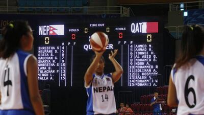 Members of Nepal's women's basketball team warm up before their Qatari opponents failed to show up due to the hijab ban at the Asian Games. Jason Reed / Reuters