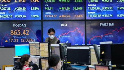 Stock market boards in Seoul. Asian shares rose Friday after US stocks recovered at the end of a wild trading day. AP