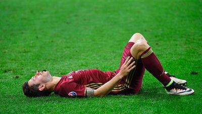 Russia’s forward Fedor Smolov lies on the field at the end of the Euro 2016 group B football match between Russia and Slovakia at the Pierre-Mauroy stadium in Villeneuve-d’Ascq, near Lille on June 15, 2016. / AFP / Joe KLAMAR