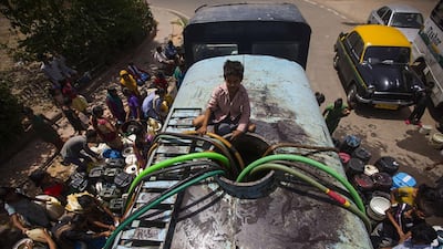 A government water tanker provides New Delhi residents with drinking water. Andrew Caballero-Reynolds / AFP