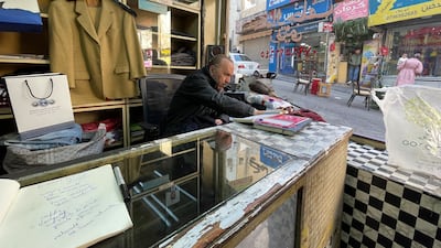 The main tools of his trade are a clamp to stretch the fabric and a needle and thread